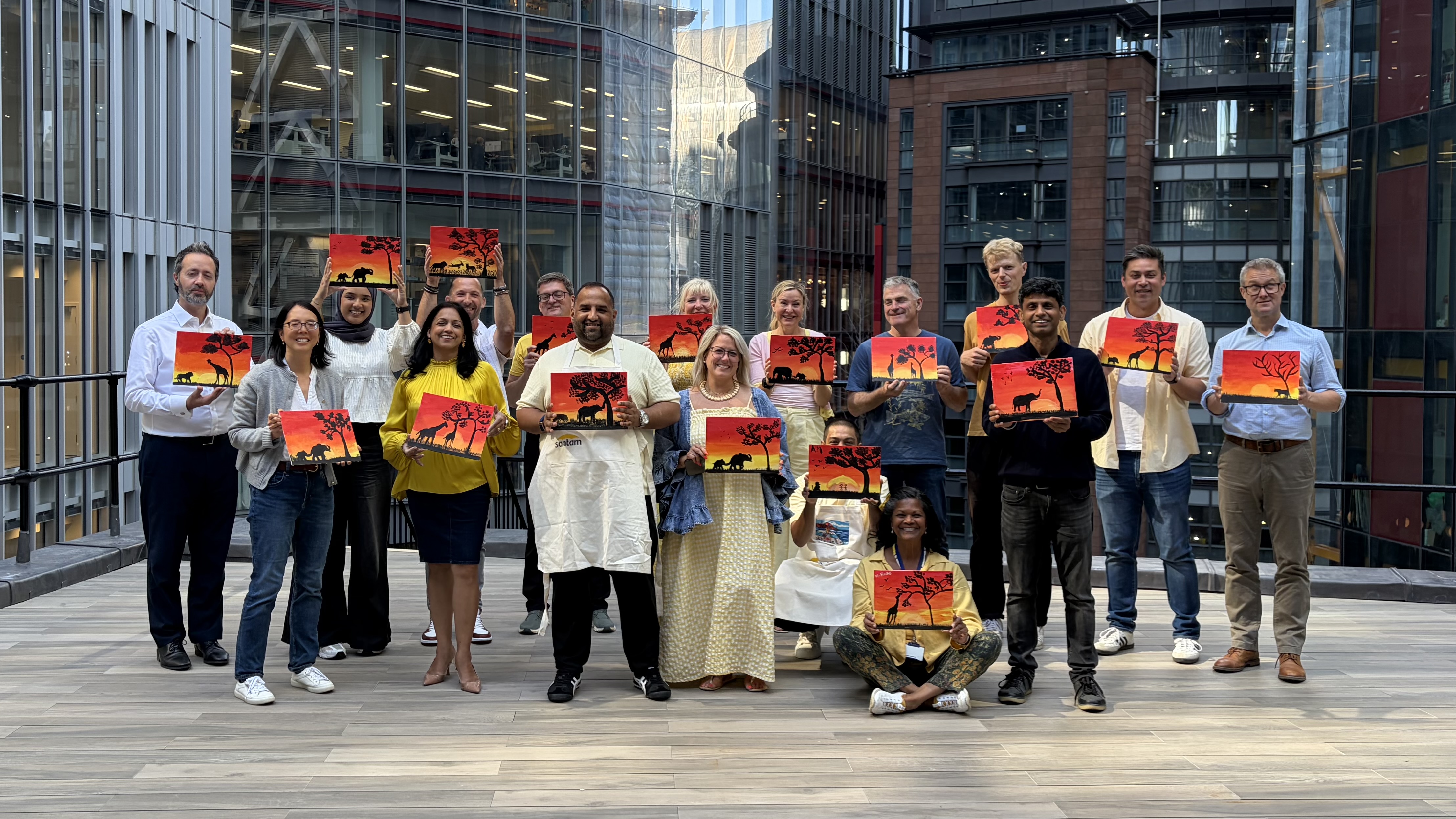 Colleagues posing after their corporate art workshop.